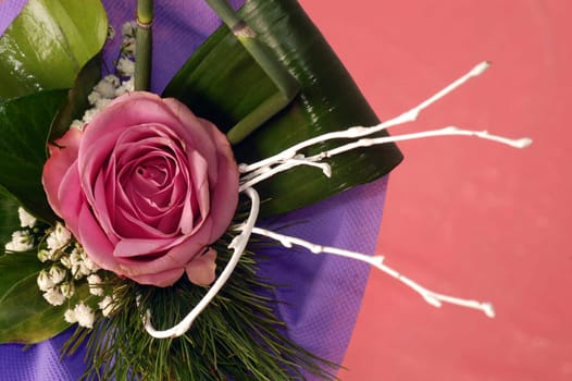 Bouquet with pink rose on pink background.