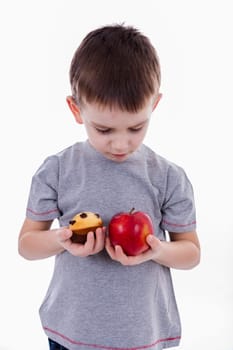 little boy with food isolated on white background - apple or a muffin