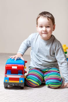 Playing little boy with colored cubes