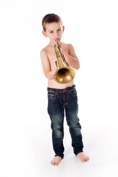 young boy blowing into a trumpet against white background