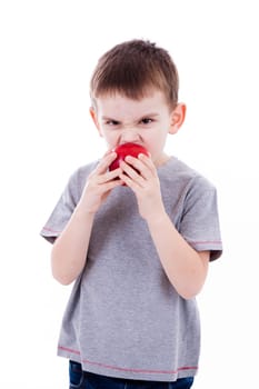 little boy with food isolated on white background - apple or a muffin