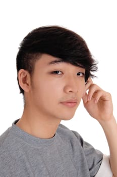 A closeup portrait image of a young Korean man with his hand on.his head, smiling, isolated for white background..
