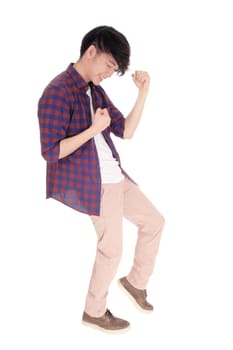 An young Asian man in a checkered shirt and sneakers dancing on his.toe, isolated for white background..