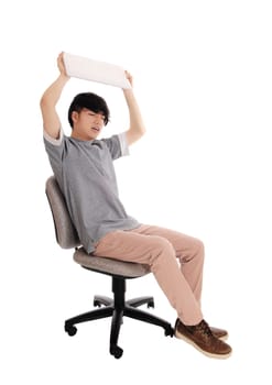 A young Asian teenager sitting on a office chair with his laptop in.his hands throwing him away, isolated for white background..