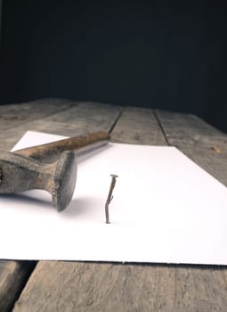 Business concept image with a concluding contract, hammer and nail on contract