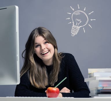 Young woman in an office working on a computer, great idea concept