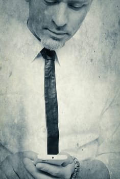 Bright textured portrait of a businessman with a mobile phone