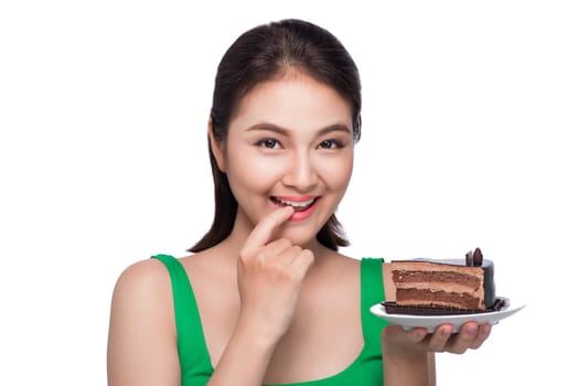 Beautiful smiling asian young woman with a chocolate cake isolated on white background.