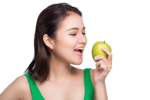 Young beautiful asian woman eating fresh green apple on white background