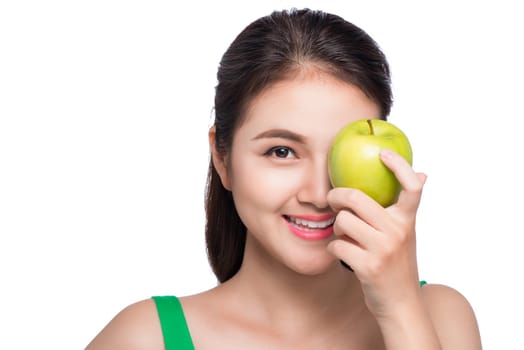 Young beautiful asian woman eating fresh green apple on white background