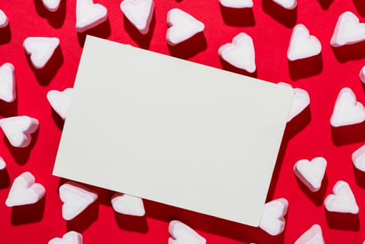 Valentines Day candy hearts marshmallows over red background
