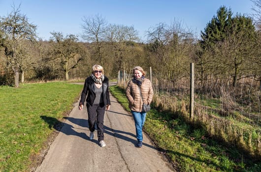 mother and daughter have a walk on a sunny day