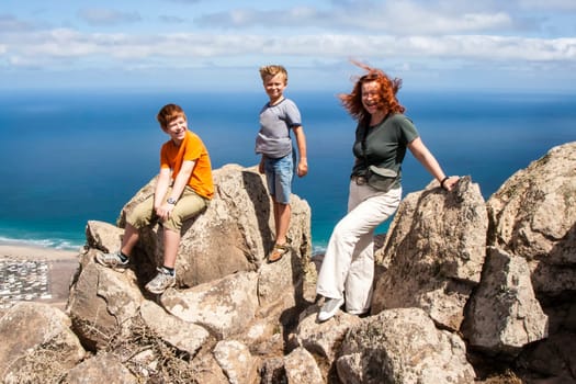 family enjoys the wind and the view in Lanzarote from the cliffs to the ocean