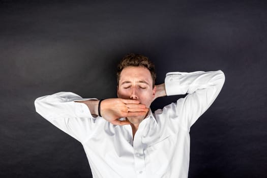 portrait of tired young man  isolated on black