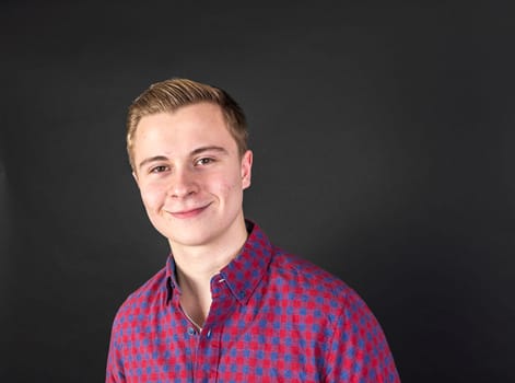 cute smiling teenage boy looks happy and confident
