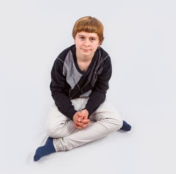 smart happy young boy posing in studio