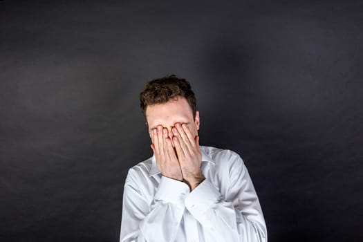 portrait of sad young man  isolated on black