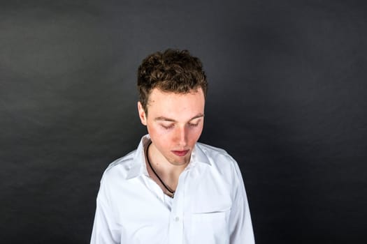 portrait of sad young man  isolated on black