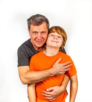 father and son hugging in studio isolated on white