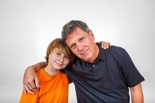 happy father and son hugging isolated on white