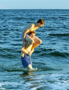 boys enjoy the beautiful beach in late afternoon  at Dauphin Islands