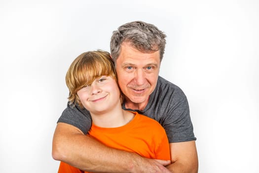 father and son hugging in studio isolated on white