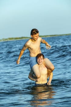 boys enjoy the beautiful beach in late afternoon  at Dauphin Islands