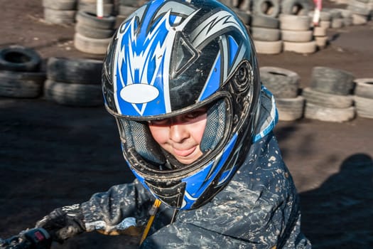 child loves to race with a quad at the muddy quad track