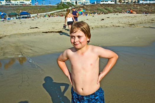 cute happy smiling boy enjoys the beach in California