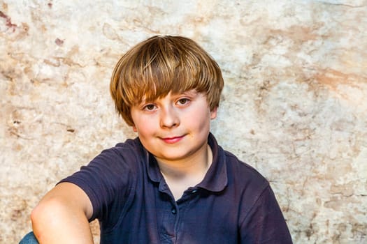 boy in the  cellar with a spotlight and an old brick wall