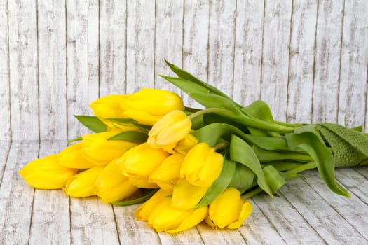 Beautiful yellow tulip bouquet on background with structure