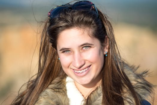Beautiful and happy young girl posing outdoors