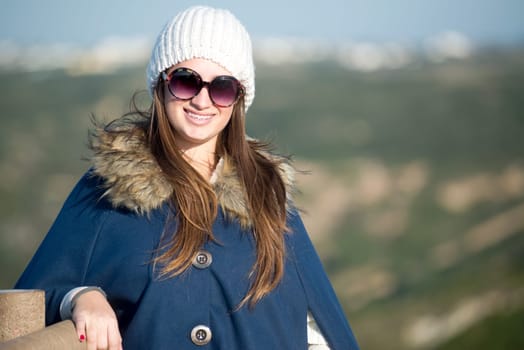 Beautiful and happy young girl posing outdoors