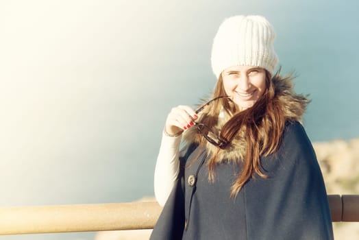 Beautiful and happy young girl posing outdoors