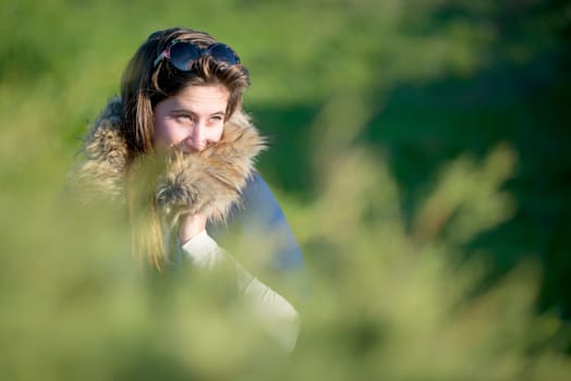Beautiful and happy young girl posing outdoors