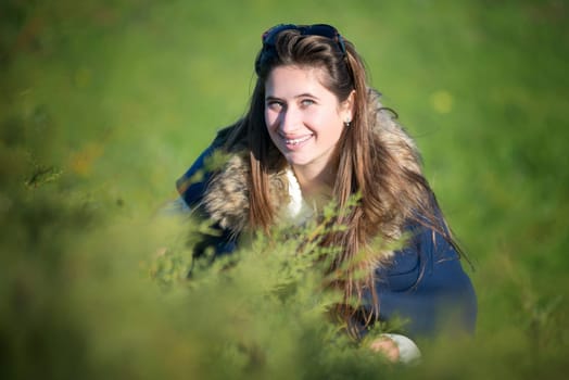 Beautiful and happy young girl posing outdoors