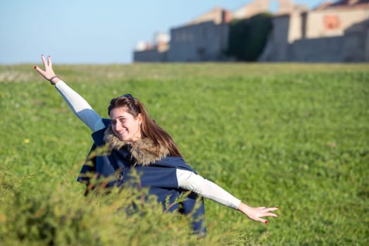 Beautiful and happy young girl posing outdoors