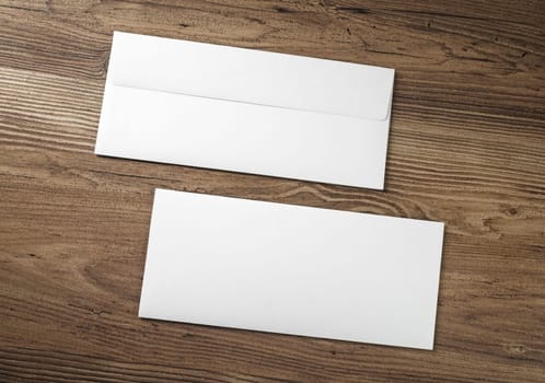 Blank envelopes on wood table background. . Front and back side.
