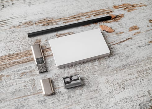 Bank business cards, pencil, flash drive and sharpener. Blank paperwork template. Responsive design mockup on vintage wood background.