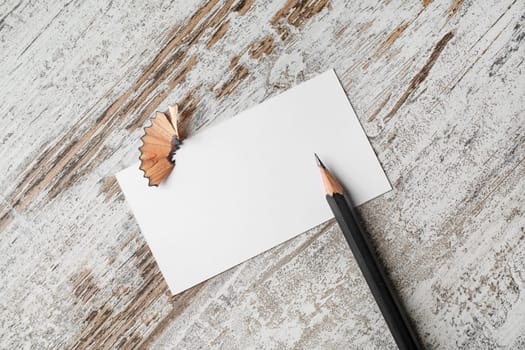 Bank business card and pencil on vintage wooden table background.