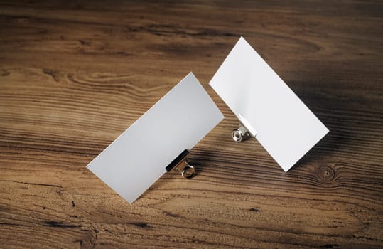 Photo of blank business cards on vintage wood table background. Mock up for ID. Blank template for branding identity for designers.