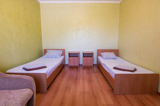Sleeps - bed and two bedside tables in the interior of the guest room in the house, close-up
