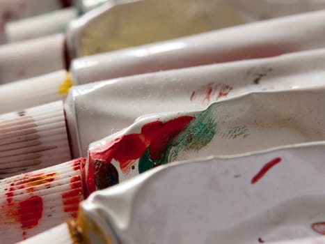 close up of used and dirty paint tubes in studio pressed