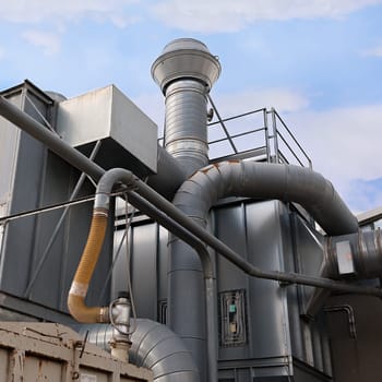 Industrial factory air filtration system. Tubes, tank and chimney.