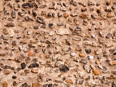 beautiful brick wall of cobble outside of church on cloudy day