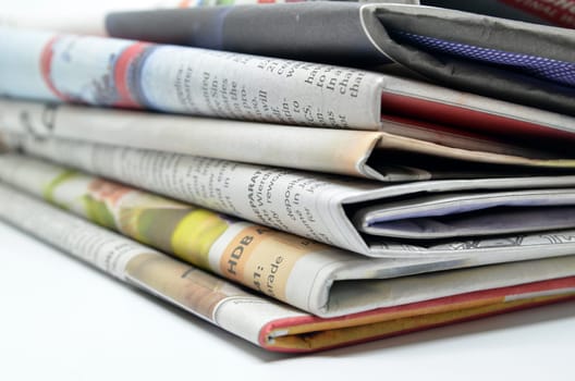 Newspapers folded and stacked isolated on white