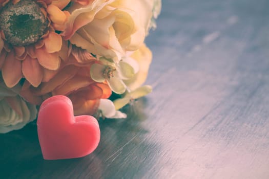 Heart with flowers on wooden of vintage.