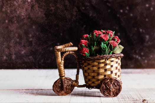 Potted roses on the old wooden bike.