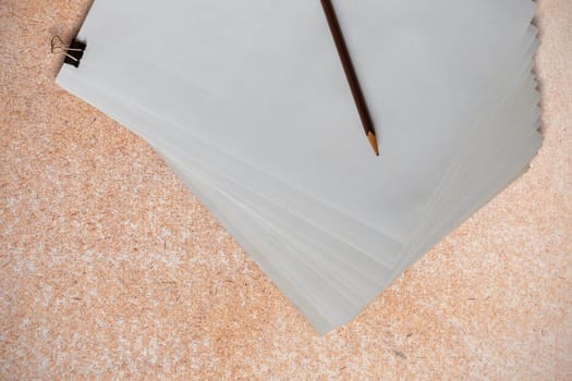 Paper and pencil on the old wooden floor.