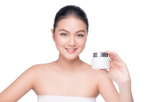 Beauty treatment. Asian woman holding moisturizing cream box.